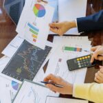 Business professionals analyzing financial charts and graphs during a meeting.