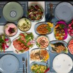 A colorful spread of Middle Eastern dishes including hummus, salads, and grilled vegetables, perfect for a festive gathering.